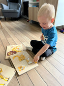 Puslespilsreol med 12 knop-puslespil